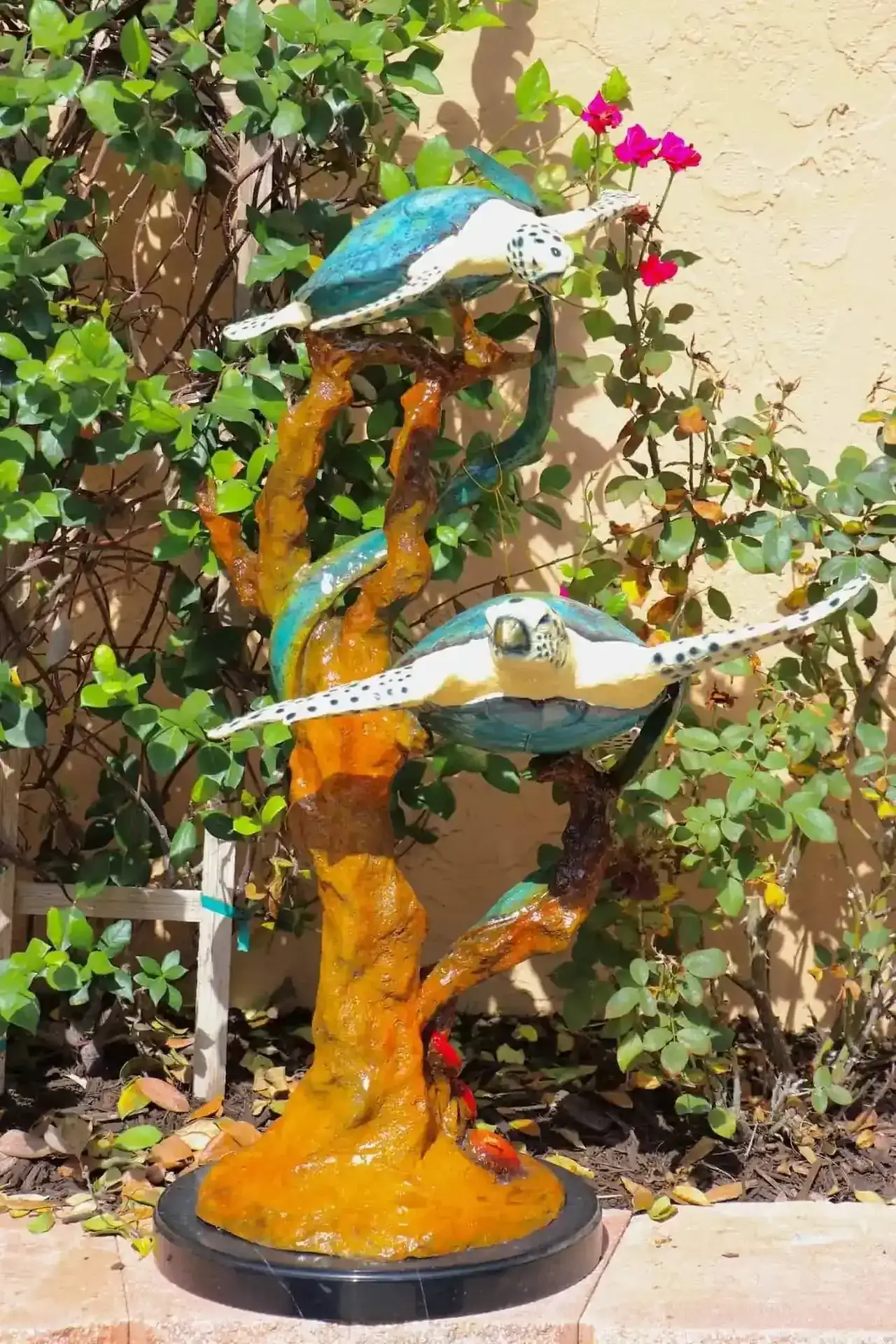 Two turtles with coral statuary in a special patina finish