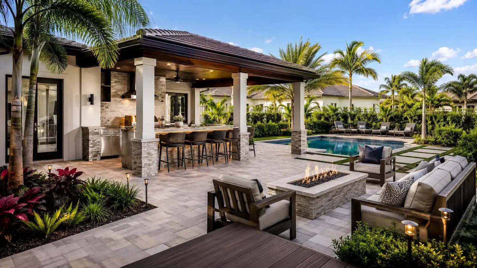 Covered outdoor kitchen, fire pit, and pool deck completed on a Tampa Bay property