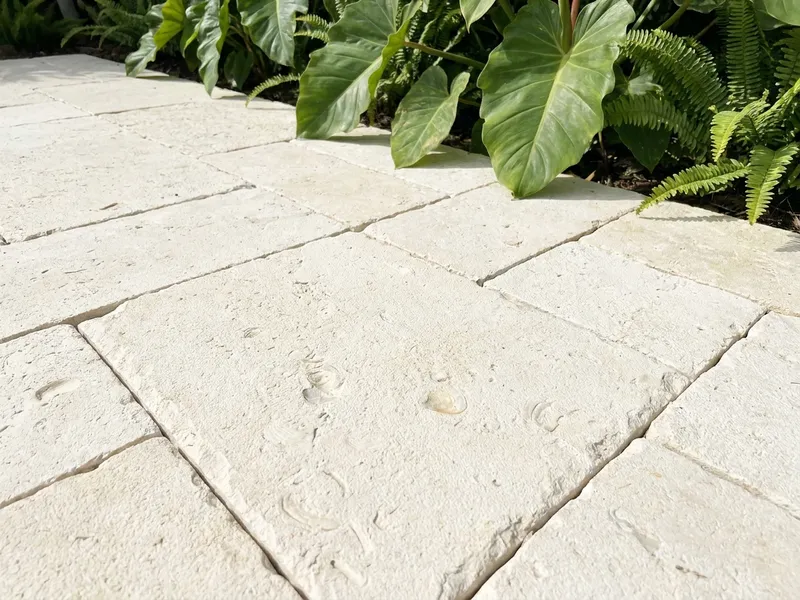Pale limestone paver patio with a honed surface
